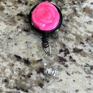 Pink flower and diamond badge reel.